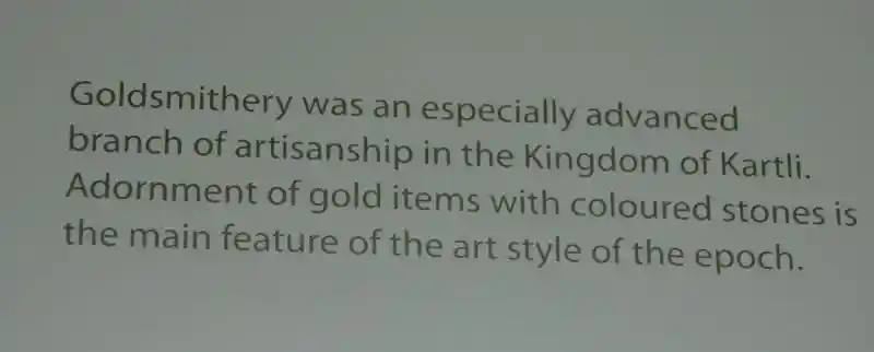 Gold disc with red stones around